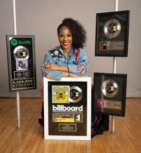 Samota Acklin poses with her mothers recent awards Photo by Victor Powell