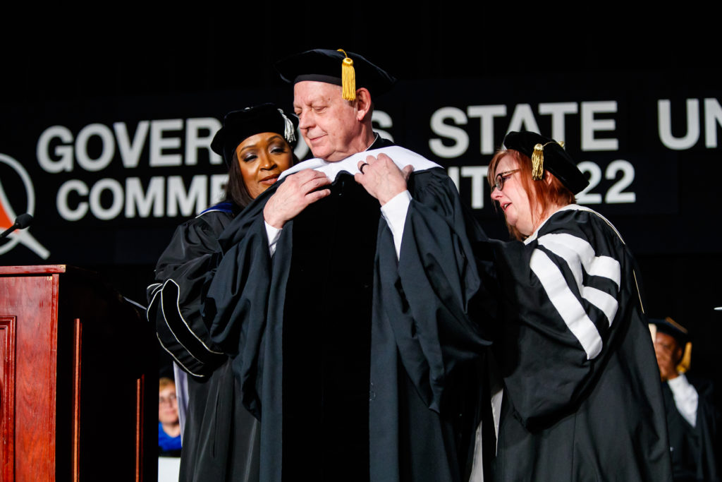 GOVERNOR STATE UNIVERSITY honored St. Sabina’s Father Michael Pfleger with an honorary doctorate degree during the 2022 Commencement ceremony on May 14 at the Tinley Park Convention Center. The occasion also marked Father Pfleger’s 47th anniversary as an ordained priest in the Archdiocese of Chicago. (Photo courtesy of Governors State University)