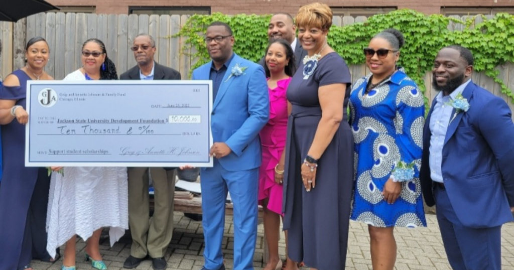 PICTURED HOLDING THE $10K donation to the Jackson State University Development Foundation from, l-r, first row, are Brendolyn Hart Glover, president, JSUNAA; Annette Johnson, and Greg Johnson, donors; JSU President Thomas Hudson; Keisha Johnson; Earlexia Norwood, M.D., JSUNAA President; Yolanda R. Owens, assistant vice president of JSU Development; and David Howard, director of JSU Alumni Affairs. Second row, standing behind Keisha Johnson is Ezra Johnson.