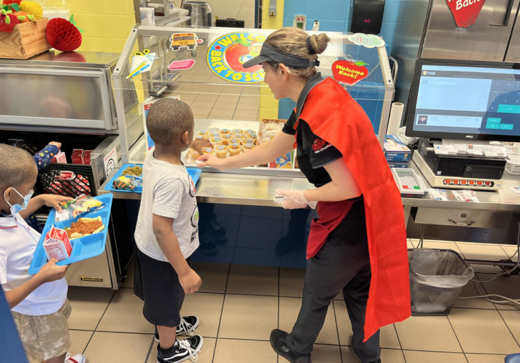 O’BANNON ELEMENTARY SCHOOL food service workers are superheroes, turning their aprons into capes.