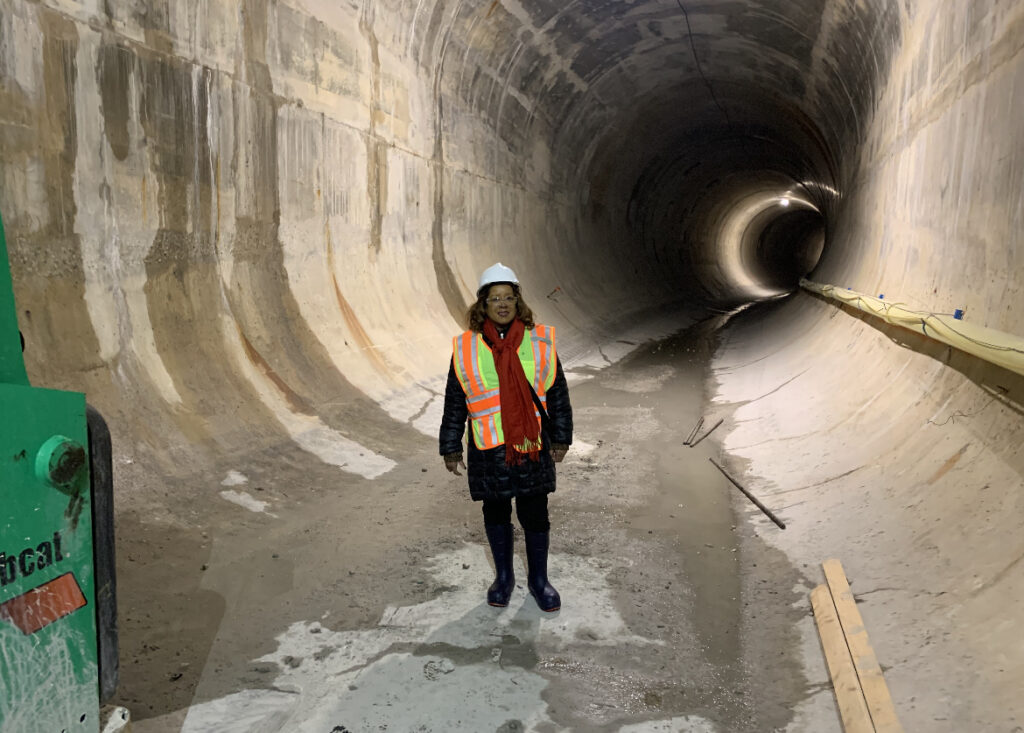 COOK COUNTY MWRD Commissioner Kim Du Buclet is pictured wearing a hard hat in one of the deep tunnels.