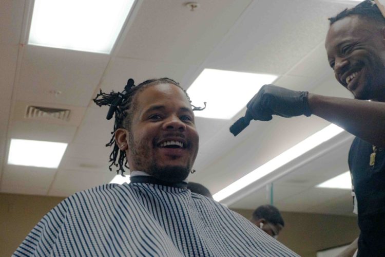 PHOTO OF A satisfied client getting his hair cut in Larry’s Barber Maximus Salon.