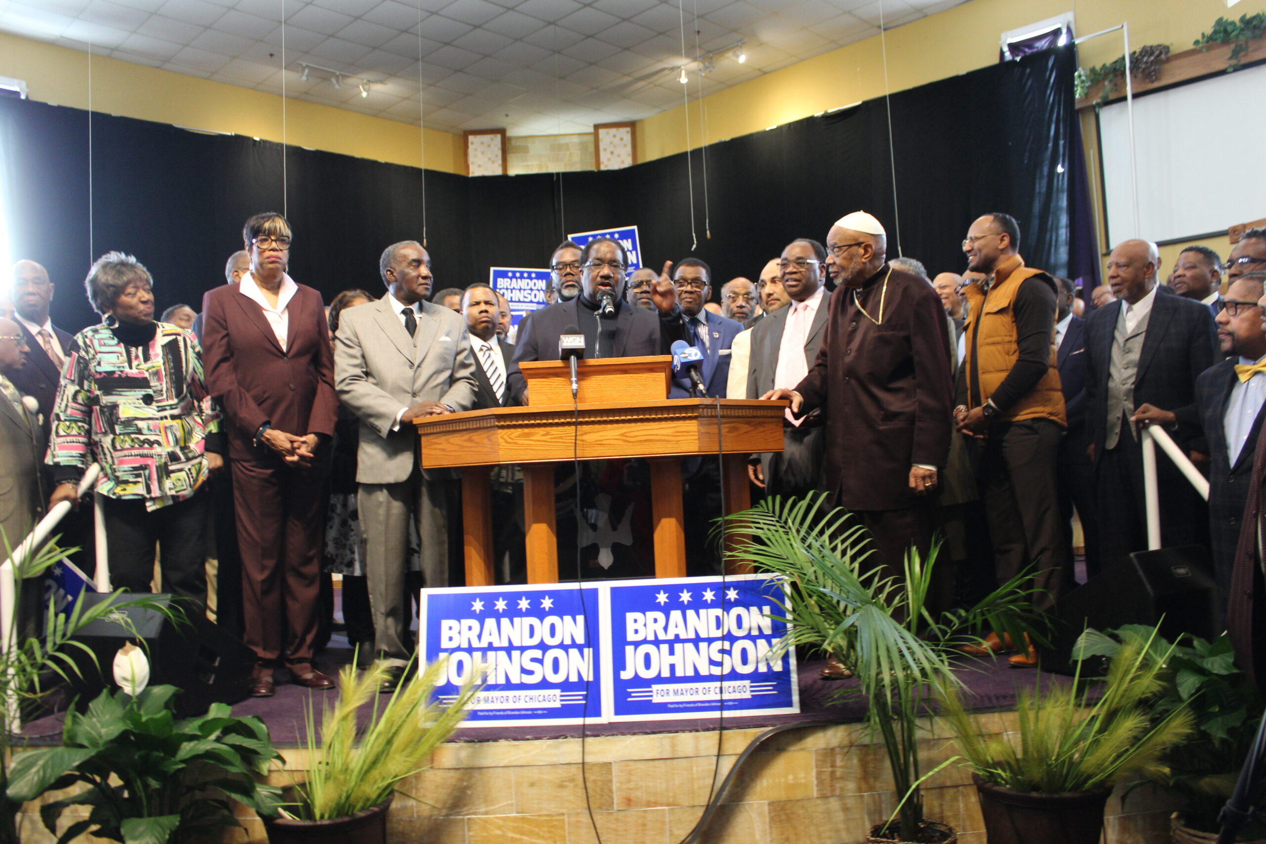 REV. MARSHALL HATCH at the podium of an event hosted by mayoral candidate Brandon Johnson explaining why he fired Paul Vallas. (Photo by Chinta Strausberg)