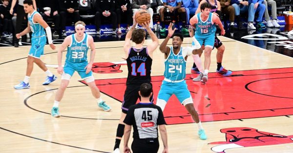 Chicago Bulls rookie Matas Buzelis (14) pulls up for a jumper as Charlotte Hornets forward Brandon Miller (24) raises his arms to contest the shot during Saturday’s game at the United Center. (Photo by Marcus Robinson for the Chicago Crusader Newspaper)