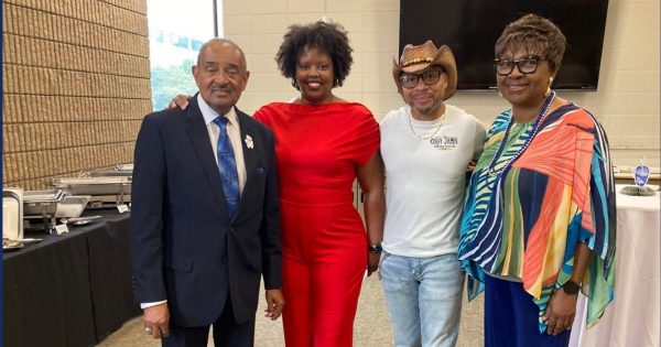 DR. VERNON SMITH, left, and Kelly May, a former Nobel Elementary student, Troy Charles, 
and Althea Range at IU Northwest's June 13th retirement dinner for Dr. Smith.