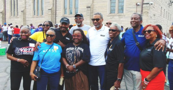 NAACP President and CEO Derrick Johnson, center in white, is pictured next to Robert Buggs to his left and Gary Branch President Steve Mays, along with NAACP leaders and members during the relief giveaway.