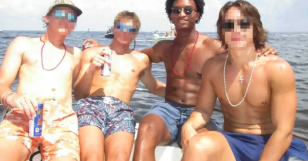 Nolan Wells (second from right) poses with three other individuals aboard a boat in an undated family-provided photograph.